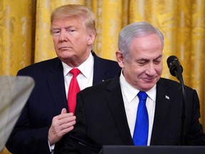 In this file photo taken Jan. 28, 2020, U.S. President Donald Trump and Israeli Prime Minister Benjamin Netanyahu take part in an announcement in the East Room of the White House, in Washington D.C.