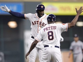 Astros' Yordan Alvarez celebrates with third base coach Gary Pettis after a home run during the third inning against the Twins during Game 1 of the AL Division Series at Minute Maid Park in Houston, Saturday, Oct. 7, 2023.