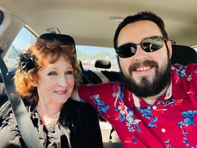 Selfie of elderly woman with red hair and young man with slicked back hair and beard