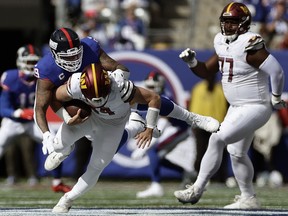 New York Giants defensive end Leonard Williams (99) sacks Washington Commanders quarterback Sam Howell (14) during the first quarter of an NFL football game, Sunday, Oct. 22, 2023, in East Rutherford, N.J.