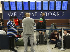 Passengers wait in line at Hartsfield-Jackson International Airport