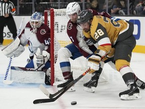 Vegas Golden Knights left wing William Carrier (28) attempts to skate around Colorado Avalanche defenseman Devon Toews (7) during the second period of an NHL preseason hockey game Thursday, Oct. 5, 2023, in Las Vegas.