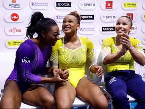 From left: United States' Simone Biles, Brasil's Rebeca Andrade and Brasil's Flavia Saraiva wait for the results after competing in the Women's Floor Final during the 52nd FIG Artistic Gymnastics World Championships, in Antwerp, northern Belgium, on Oct. 8, 2023.
