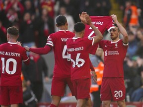Liverpool's Diogo Jota celebrates after scoring his side's opening goal holding the jersey of teammate Luis Diaz during the English Premier League soccer match between Liverpool and Nottingham Forest, at Anfield in Liverpool, England, Sunday, Oct. 29, 2023.