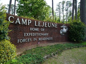 Signage stands on the main gate to Camp Lejeune