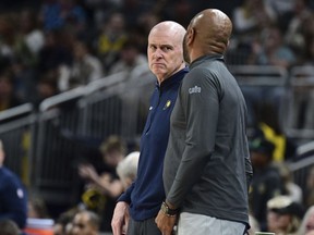Indiana Pacers head coach Rick Carlisle, center left, has a word with Cleveland Cavaliers head coach J. B. Bickerstaff, center right, during the second half of a preseason NBA basketball game, Friday, Oct. 20, 2023, in Indianapolis.