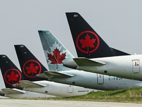 Air Canada planes sit on the tarmac