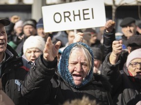 People shout anti-government slogans during a protest initiated by the Movement for the People and members of Moldova's Russia-friendly Shor Party, against the pro-Western government and low living standards, in Chisinau, Moldova, Sunday, March 12, 2023.