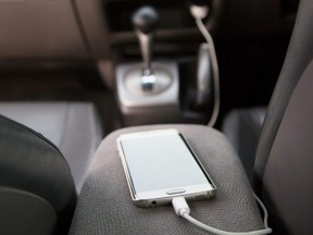 A cellphone gets charged inside a vehicle.