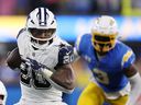 Tony Pollard of the Dallas Cowboys runs the ball against the Los Angeles Chargers at SoFi Stadium on October 16, 2023 in Inglewood, California.