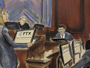 In this courtroom sketch, FTX founder Sam Bankman-Fried, background center, is cross examined by U.S. Assistant Attorney Danielle Sassoon, left, while Judge Lewis Kaplan listens, background second left, in Manhattan federal court, Monday, Oct. 30, 2023, in New York. Members of the jury are seated at right.