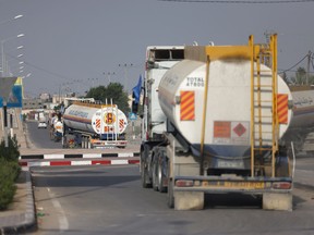 Trucks carrying fuel enter the Gaza Strip
