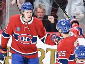Montreal Canadiens' Kaiden Guhle (21) celebrates with teammate Denis Gurianov (25) after scoring against the New York Rangers during first period NHL hockey action in Montreal, Thursday, March 9, 2023. Guhle is out day-to-day with an upper-body injury, the team announced Thursday. THE&ampnbsp;CANADIAN PRESS/Graham Hughes