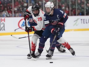 The PWHL, slated to begin play in January, represents a seismic shift in the women's game, which has provided some of the sport's iconic moments at the Olympics and world championships with the heated Canada-U.S. rivalry, but has struggled to gain traction in North America with a financially sustainable pro model. USA forward Hilary Knight (21) and Canada forward Marie-Philip Poulin (29) battle during second period IHF Women's World Hockey Championship gold medal hockey action in Brampton, Ont., on Sunday, April 16, 2023.