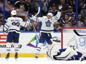 Maple Leafs captain John Tavares (91) celebrates with winger William Nylander (88) after Tavares scored past Lightning goaltender Jonas Johansson during overtime action in Tampa, Fla., Saturday, Oct. 21, 2023.