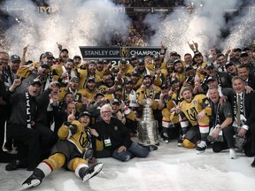 The Vegas Golden Knights pose with the Stanley Cup .
