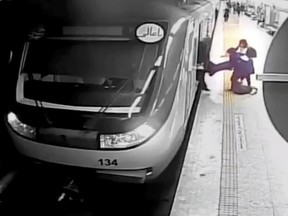 women pull 16-year-old Armita Geravand from a train