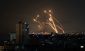 An Israeli missile launched from the Iron Dome defence missile system attempts to intercept a rocket, fired from the Gaza Strip, over the city of Netivot in southern Israel on Oct. 8, 2023.
