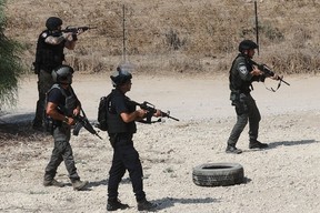 Israeli forces, dispatched to the border with Gaza in southern Israel, scan the area near Ashdod on Oct. 8, 2023 as the battle against holdout Hamas fighters continues.