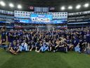 Toronto Blue Jays celebrate on the field after clinching a berth in the American League playoffs in Toronto, Sunday, Oct. 1, 2023. 