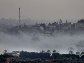 Israeli artillery shelling smoke covers Dahaira, a Lebanese border village with Israel, south Lebanon, Monday, Oct. 16, 2023.