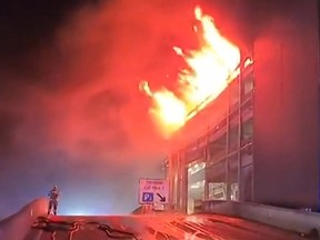 a parking structure on fire at London's Luton Airport