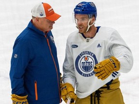 Connor McDavid speaks to assistant coach Dave Manson after practice on Friday, Oct. 13, 2023 in Edmonton. The Oilers were wearing their new gear for the Heritage Classic which will be played on Oct. 28, 2023.