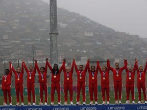 Canada's players celebrate at the podium after receiving their gold medals for women's rugby 7 at the Pan American Games in Lima, Peru, Sunday, July 28, 2019. A team of 473 athletes will represent Canada at the upcoming Pan American Games in Santiago, Chile.