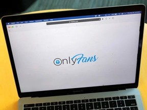 The OnlyFans logo displayed on a laptop