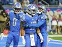 Detroit Lions running back Craig Reynolds (13) celebrates his touchdown with wide receiver Kalif Raymond and wide receiver Marvin Jones Jr. (0) in the second half of an NFL football game against the Carolina Panthers in Detroit, Sunday, Oct. 8, 2023.