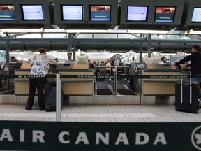Air Canada passengers check in at the Vancouver International Airport on June 17, 2008. Air Canada says the country's passenger rights overhaul will hardly hurt its bottom line.THE CANADIAN PRESS/Darryl Dyck