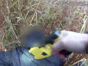 This frame grab from Naugatuck, Conn., Police Department body camera video, with parts of the video blurred by the source, shows Naugatuck Officer Nicholas Kehoss pulling a stun gun trigger for about five seconds during one of multiple times as he yells at a shoplifting suspect, telling him to "shut up" and calling him an "idiot" during an arrest, Oct. 14, 2023. Naugatuck Police Chief C. Colin McAllister said Monday, Oct. 30, 2023, that state police were investigating Kehoss' use of force, and the department is doing an internal affairs investigation. (Naugatuck Police Department via AP)