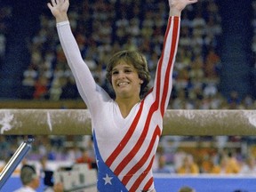 FILE- Mary Lou Retton reacts to applause after her performance at the Summer Olympics in Los Angeles on Aug. 3, 1984. Retton. 55, is in intensive care in a Texas hospital fighting a rare form of pneumonia, according to her daughter McKenna Kelley.