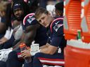 New England Patriots quarterback Mac Jones, right, is seated on the bench after he was pulled during the second half of an NFL football game against the New Orleans Saints, Sunday, Oct. 8, 2023, in Foxborough, Mass.