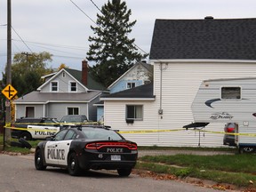 Police tape and vehicles surround a crime scene in Sault Ste. Marie