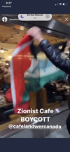 A protester waves Palestinian flag outside a restaurant with Jewish roots than demonstration organizers are calling on people to boycott