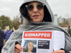 Olga Goldberg holds up a poster of Gaza hostage Mia, her daughter's friend, who was kidnapped Oct. 7