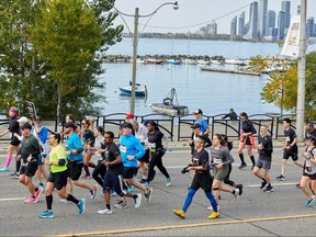 Toronto Waterfront Marathon runners by Lake Ontario.