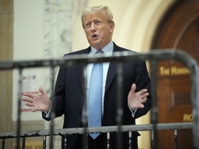 Former President Donald Trump speaks as he returns to the courtroom after the lunch break of his civil business fraud trial, Wednesday, Oct. 18, 2023, at New York Supreme Court in New York.