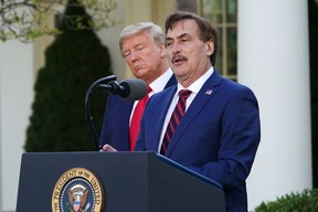 U.S. President Donald Trump listens as Michael J. Lindell, CEO of MyPillow Inc., speaks during the daily briefing on COVID-19 in the Rose Garden of the White House in Washington, D.C., on March 30, 2020.
