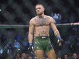 UFC star Conor McGregor stands in the octagon during a fight.