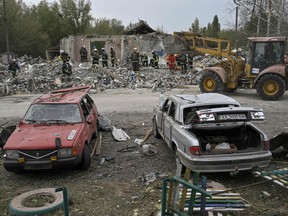 Ukrainian emergency personnel clear debris