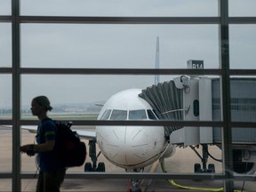 A traveller walks past a United Airlines aircraft, ahead of the July 4th holiday, at Ronald Reagan Washington National Airport in Arlington, Virginia, on July 1, 2023.