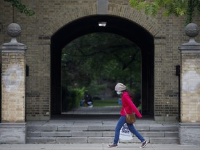 A woman walks on the University of Toronto campus.