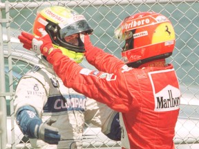 Brothers Ralf (left) and Michael Schumacher hug at the Formula 1 Canadian GP in Montreal.
