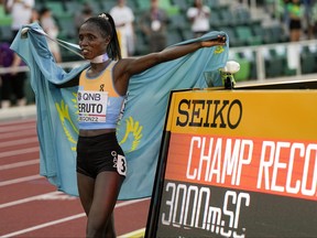 Norah Jeruto of Kazakhstan celebrates after winning the women's 3000-meter steeplechase final at the World Athletics Championships.
