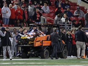 Perris Jones of the Virginia Cavaliers is taken off the field after being injured in the game against the Louisville Cardinals.