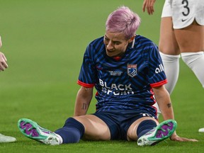 OL Reign's Megan Rapinoe reacts on the pitch after suffering an injury.