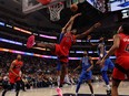 O.G. Anunoby of the Toronto Raptors gets fouled by Kyrie Irving of the Dallas Mavericks as he shoots.