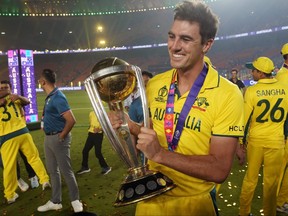 Australia's captain Pat Cummins poses with the trophy after Australia won the ICC Men's Cricket World Cup.